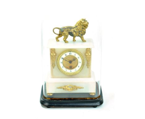 A late 19th century alabaster mantel clock with gilt metal lion finial and mounts, the porcelain chapter ring set with Arabic