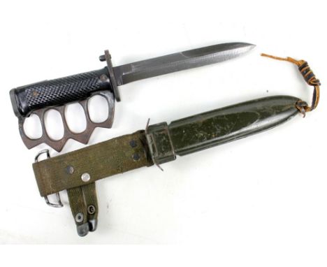 A US fighting knife with blackened blade and crossguard stamped 'U.S. M5A1 Mil Par Col' with chequered grip with 'knuckle dus