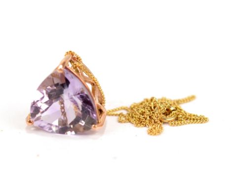 A 9ct gold and purple tourmaline pendant on a yellow metal curb link chain stamped 375 to clasp, length of chain 46cm, approx