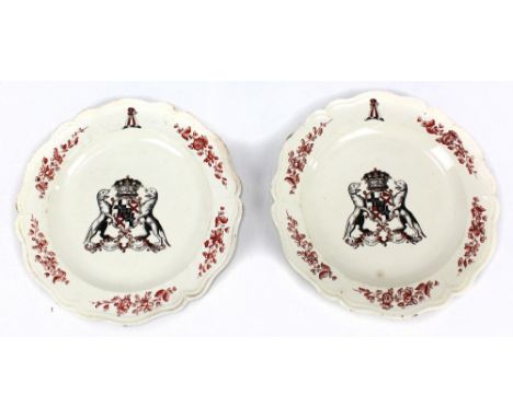 A pair of 18th century creamware plates with crimped rims, painted foliate detail and central armorials, possibly for House o