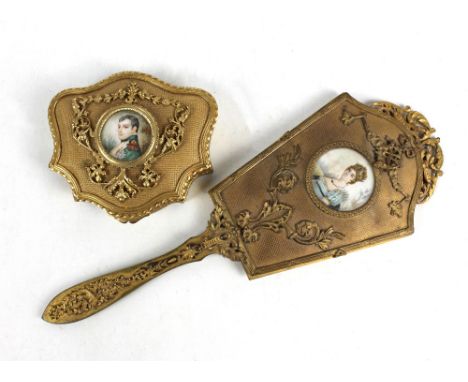 NAPOLEONIC INTEREST; a 19th century French gilt metal lady's hand mirror with foliate scroll detail and inset gouache on ivor