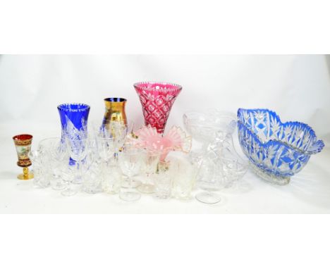 A mixed lot of clear and coloured cut glass to include vases, bowls, wine glasses, etc.