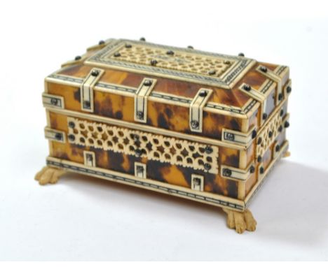 A 19th century tortoiseshell and ivory bound casket with pen work detail, on bone paw feet (one af), 9 x 5.5cm x 5cm.Addition