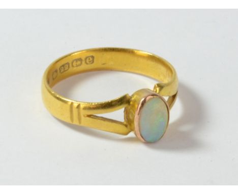 A 22ct yellow gold ring set with oval cut opal, size W, approx 5.5g.