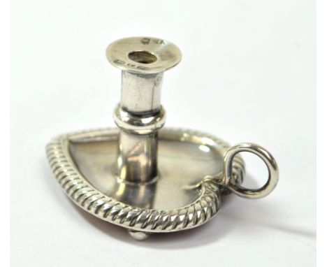 A Victorian hallmarked silver miniature chamber stick on heart shaped base with three stud feet and Moroccan leather lining, 