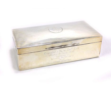 A George V hallmarked silver rectangular cigarette box with reeded decoration to lid, lid with indistinct monogram and engrav