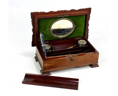 A small mahogany desk stand with twin clear glass hallmarked silver topped inkwells, interior for restoration, and two Parker