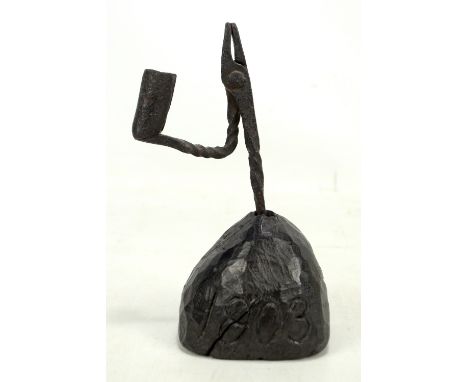 A George III wrought iron rush light on adzed oak base inscribed '1803', height 21cm (the light detached from base).Additiona