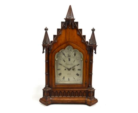 THOMPSON &amp; VINE OF LONDON; a good late 19th century Gothic Revival oak mantel clock, the silvered dial set with Roman num