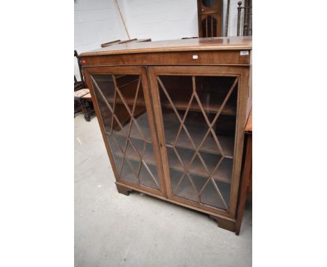 An early 20th Century bleached mahogany bookcase on bracket feet