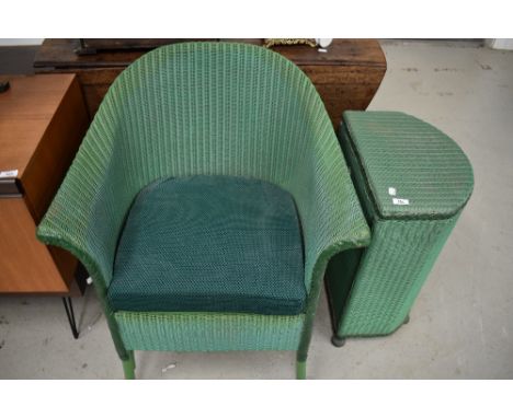 A painted green wicker Lloyd Loom style laundry basket and a basket chair/commode, dated 1950.