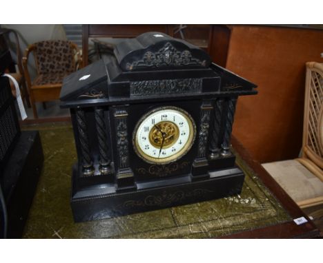 A Victorian black marble mantel clock