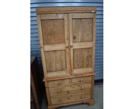 A Victorian stripped pine housekeepers or similar cupboard having later wardrobe interior over three drawer base on bracket f