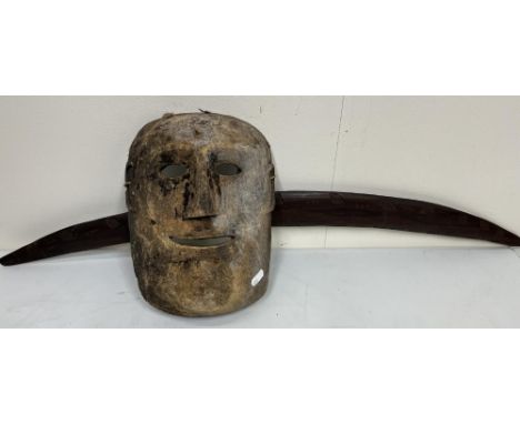 Tibetan - Nepalese carved softwood ceremonial mask, H27cm and carved hardwood Aboriginal ceremonial boomerang, L84cm