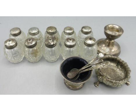 Two silver salts, silver candle stick with weighted base, five pairs of silver mounted glass salt and pepper shakers, all sta