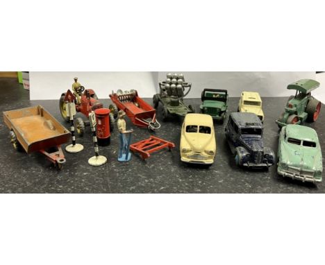 Collection of Dinky diecast vehicle models including farm trailer, tractor with driver, Austin taxi, Vanguard, etc