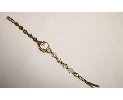 Accurist ladies 9ct gold wristwatch on integrated floral bracelet stamped .375, signed silvered sunburst dial, applied baton 