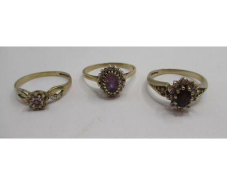 9ct yellow gold ruby and diamond cluster ring, size P, a 9ct yellow gold ring set with purple central stone, size P, and an i