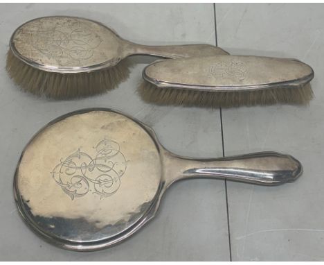 George V silver mounted dressing table trio incl two brushes and a hand mirror