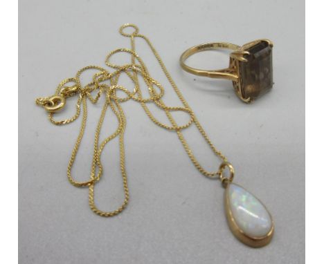 9ct yellow gold pendant set with opal, stamped 375, on 18ct gold chain, stamped 750, 2.87g, a 9ct gold ring set with smoky qu