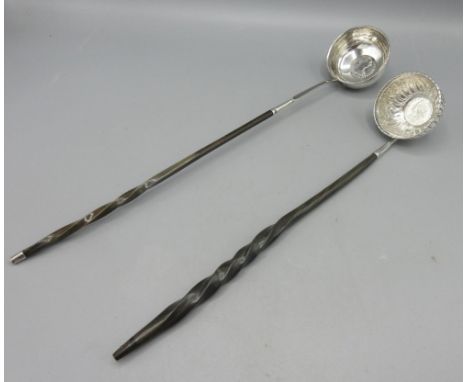 Unmarked white metal toddy ladle, bowl decorated in fruit &amp; floral repousse and George II coin, on twisted baleen handle,