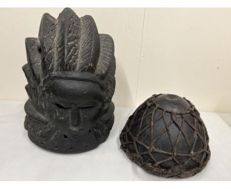 Softwood ceremonial helmet mask likely originating from the Mende People of Sierra Leone, H34cm, and a ceremonial steel backe