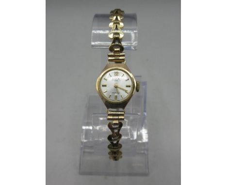 Avia ladies 9ct gold wristwatch on gold plated bracelet, signed sunburst silver dial, applied baton indices, snap on case bac