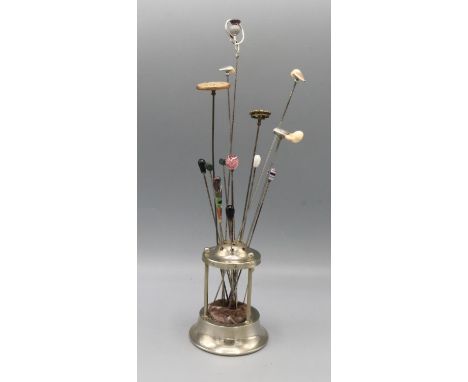Collection of hatpins, including one silver hat pin featuring stylized thistle finial set with purple stone by Charles Horner