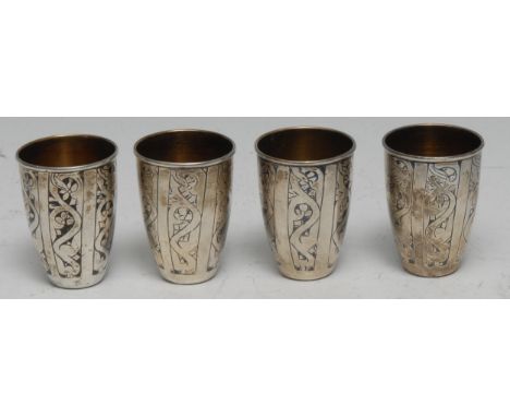 A set of four Russian silver and niello vodka cups, gilt interiors, 5cm high, Soviet marks 