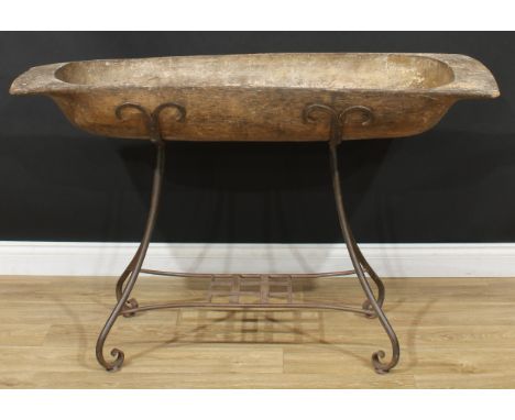 A European wooden trencher style dough bowl or trough, metal stand, 83cm high overall, the trough 19cm high, 134cm wide, 47cm