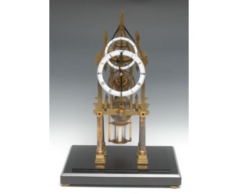 A contemporary Gothic Revival lacquered brass skeleton timepiece, 13cm enamel dial inscribed with Roman numerals, the interse