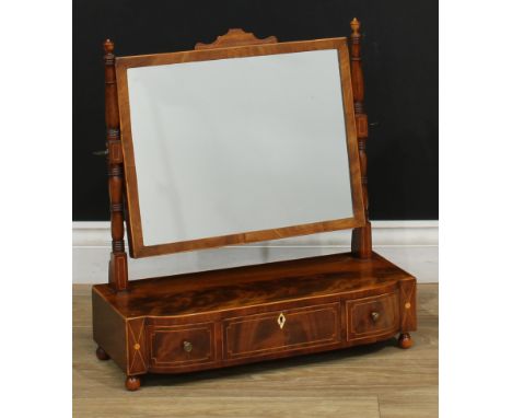 A 19th century mahogany dressing mirror, rectangular plate, ring-turned supports, bow-centre base with three frieze drawers, 
