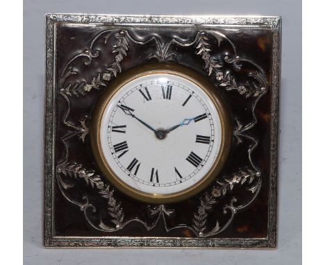 A George V silver and tortoiseshell easel strut timepiece, 4.5cm enamel clock dial inscribed with Roman numerals, 9cm high ov