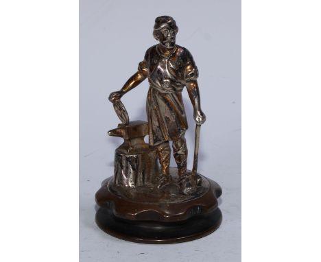 An early 20th century silver plated engine mascot, of a blacksmith, holding a wheel, 15cm high 