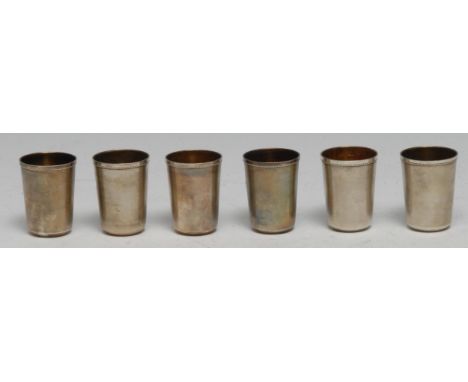 A set of six Russian silver vodka cups, quite plain, beaded borders, gilt interiors, 5cm high, Soviet mark, 198g 