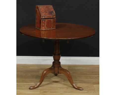 A George III oak tripod occasional table, circular tilting top, the latch cast with the letter 'N', the block stamped TT, can