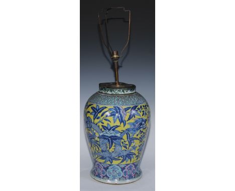 A large Chinese baluster vase, painted in tones of blue and puce with dragons on a yellow ground, 41cm high, 18th/19th centur