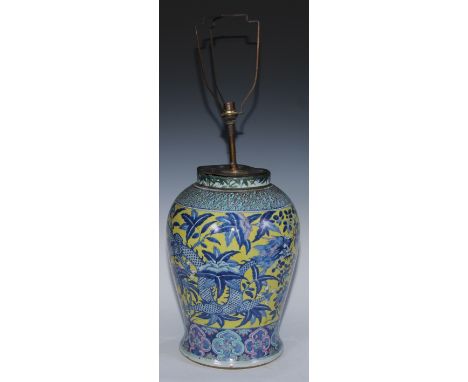 A large Chinese baluster vase, painted in tones of blue and puce with dragons on a yellow ground, 41cm high, 18th/19th centur