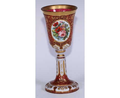 A 19th century Bohemian ruby and white overlay glass goblet, inverted bell shaped bowl painted with oval panels of a river la