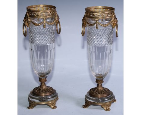 A pair of French gilt metal and cut glass mantel vases, collars cast and pierced with a band of mistletoe above ribbon tied f