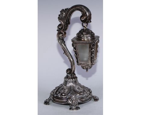 A Portuguese silver table lamp, as a lantern and post, chased throughout with scrolls and foliage, bracket feet, 27cm high, e