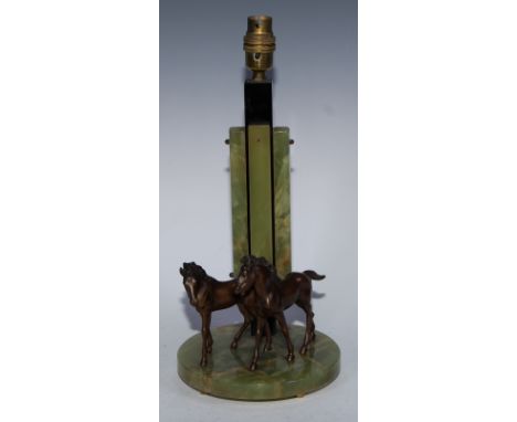 An Art Deco brown-patinated and green onyx equestrian table-lamp, the circular plateau with a pair of horse sculptures, four-