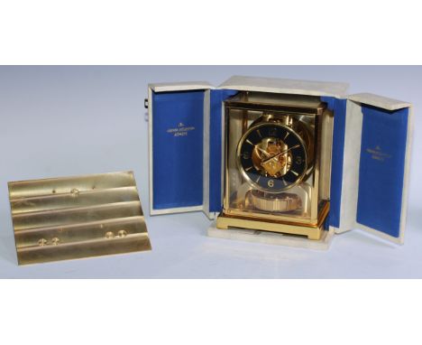 A Jaeger Le Coultre Atmos clock, 11cm dial with Arabic numerals to quarters and baton markers, lacquered brass case with brac