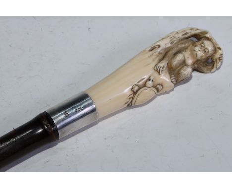 A Japanese novelty ivory walking stick handle, carved with a monkey and a turtle, the silver-mounted tapering cane terminatin