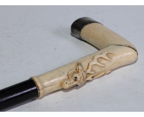 An early 20th century silver coloured metal gentleman's walking stick, the ivory L-shaped handle carved with a stag's head, e