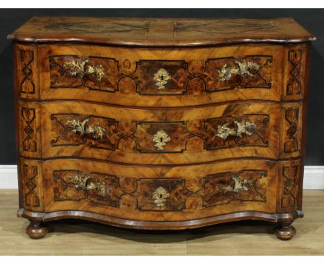 An 18th century Continental walnut and marquetry serpentine commode, probably German/Italian, oversailing top above three lon