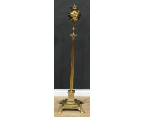 An early 20th century brass Corinthian column standard oil lamp, fluted pillar, stepped square base, lion paw feet, 152cm hig
