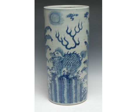 A Chinese cylinder stick stand, painted in underglaze blue with shishi dogs, flaming pearls and stiff foliage, 50cm high 