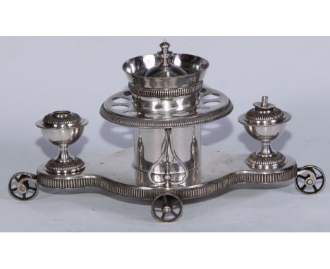 An Edwardian E.P.N.S novelty after dinner table-top cigar coaster, the centre with provision for tobacco and cigars, flanked 