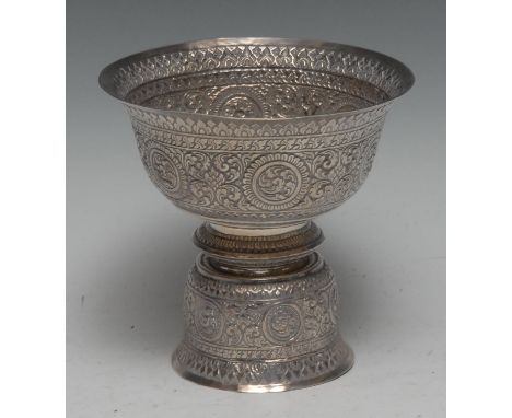 A Tibetan silver butter lamp bowl, profusely chased with mandalas and scrolling foliage, 13cm high, apparently unmarked, 168g